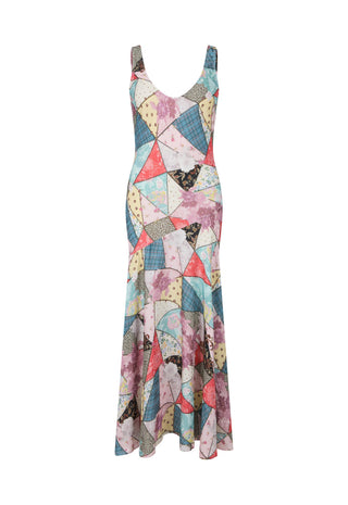 a-sleeveless-v-neck-maxi-dress-featuring-a-colorful-geometric-patchwork-print-with-triangles-and-abstract-shapes-in-pink-blue-yellow-beige-and-black-shown-against-a-plain-white-background
